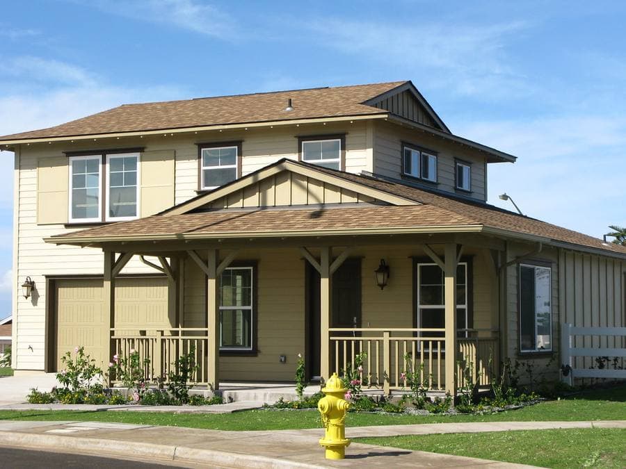Completed detached house with a covered porch and lawn