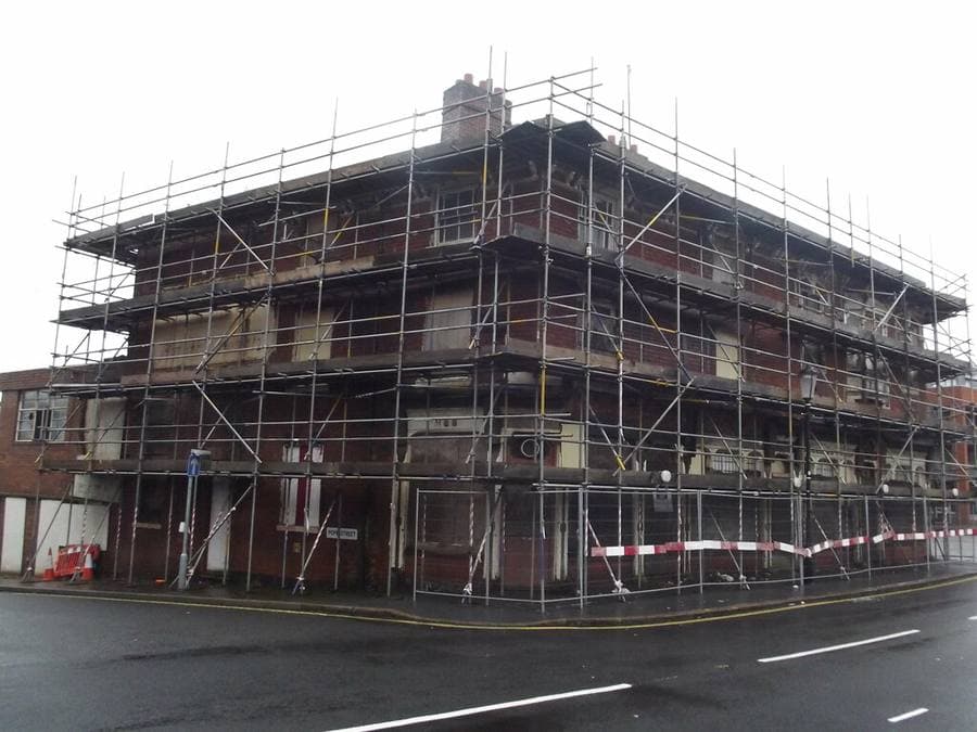 Residential building at structural stage under scaffolding