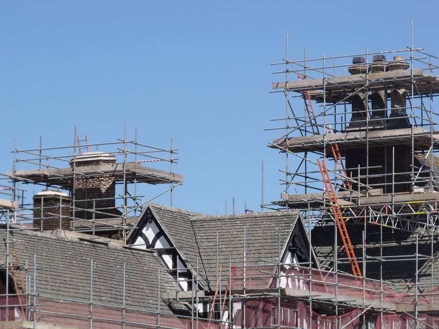 Houses under construction with roofing in progress
